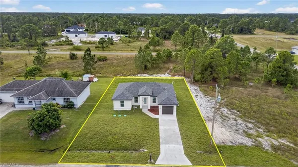 an aerial view of a house with a yard