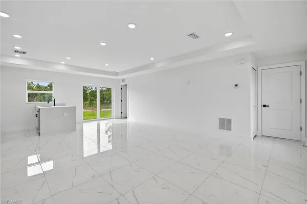 a view of kitchen with furniture and white walls