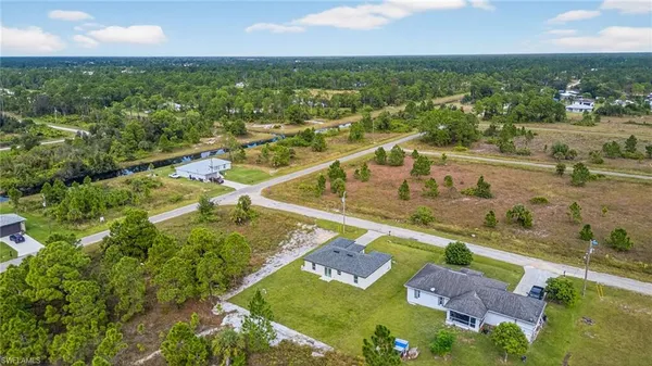 an aerial view of residential houses with outdoor space and river