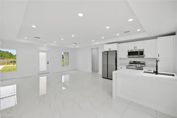 a kitchen with stainless steel appliances a refrigerator and a stove top oven