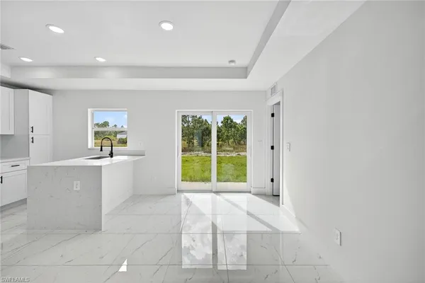 a view of a kitchen with microwave and windows