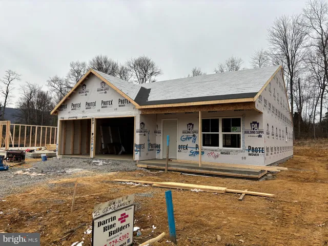 a view of a house with wooden walls and floor to ceiling window