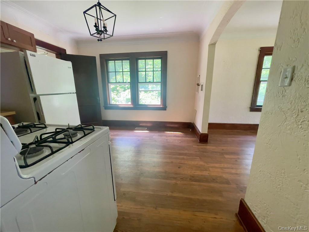 4 Old Turnpike Road Bloomingburg, NY 12721 - Photo 16 of 27 Kitchen with hanging light fixtures, dark hardwood / wood-style flooring, ornamental molding, and white appliances