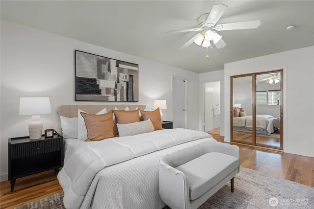 a bedroom with a large bed and a chandelier
