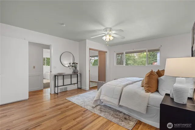 a bedroom with a bed window and a table