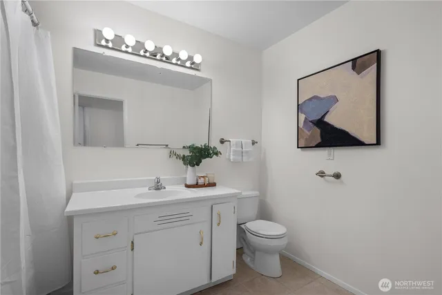 a view of empty room with a kitchen