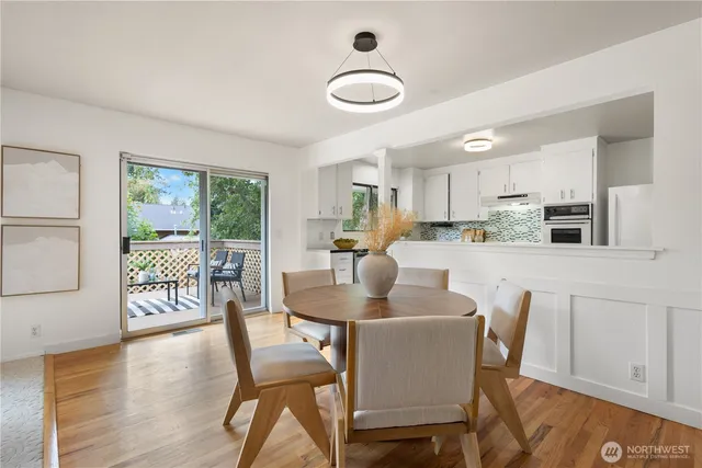 a dining room with furniture and wooden floor