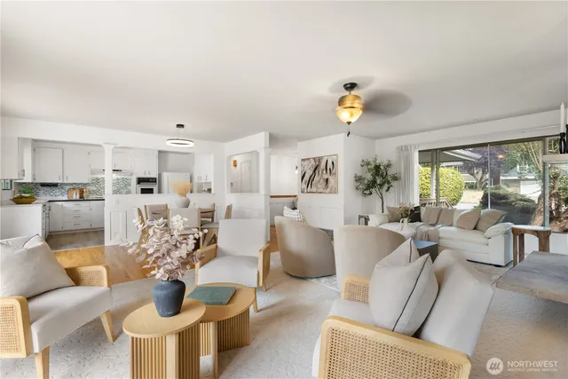 a living room with furniture white walls and a chandelier