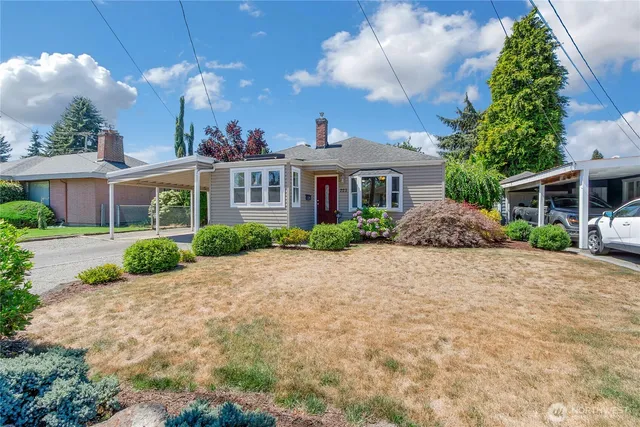 a front view of a house with a yard and a garage