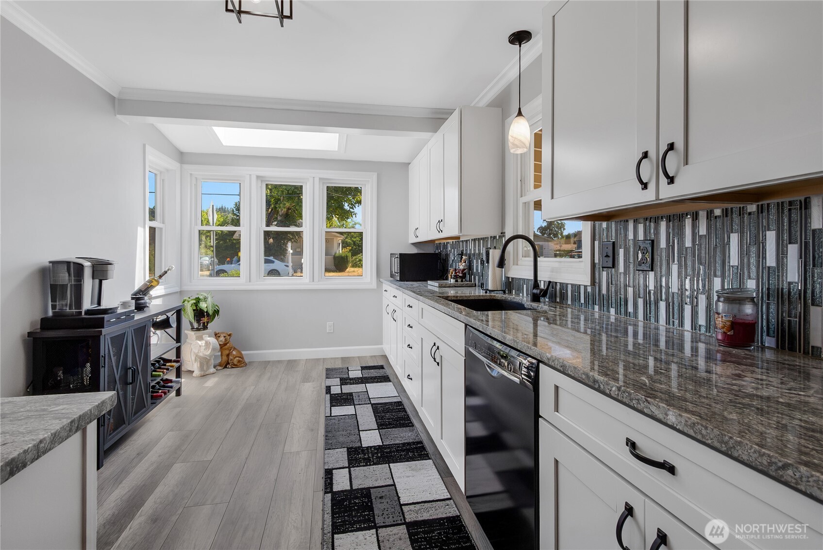 223 R Street Southeast Auburn, WA 98002 - Photo 4 of 23 a kitchen with granite countertop lots of counter top space and wooden floor