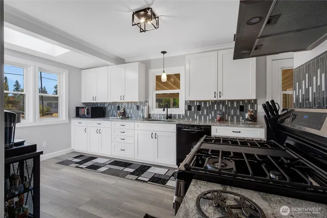 a kitchen with a stove a sink and a refrigerator