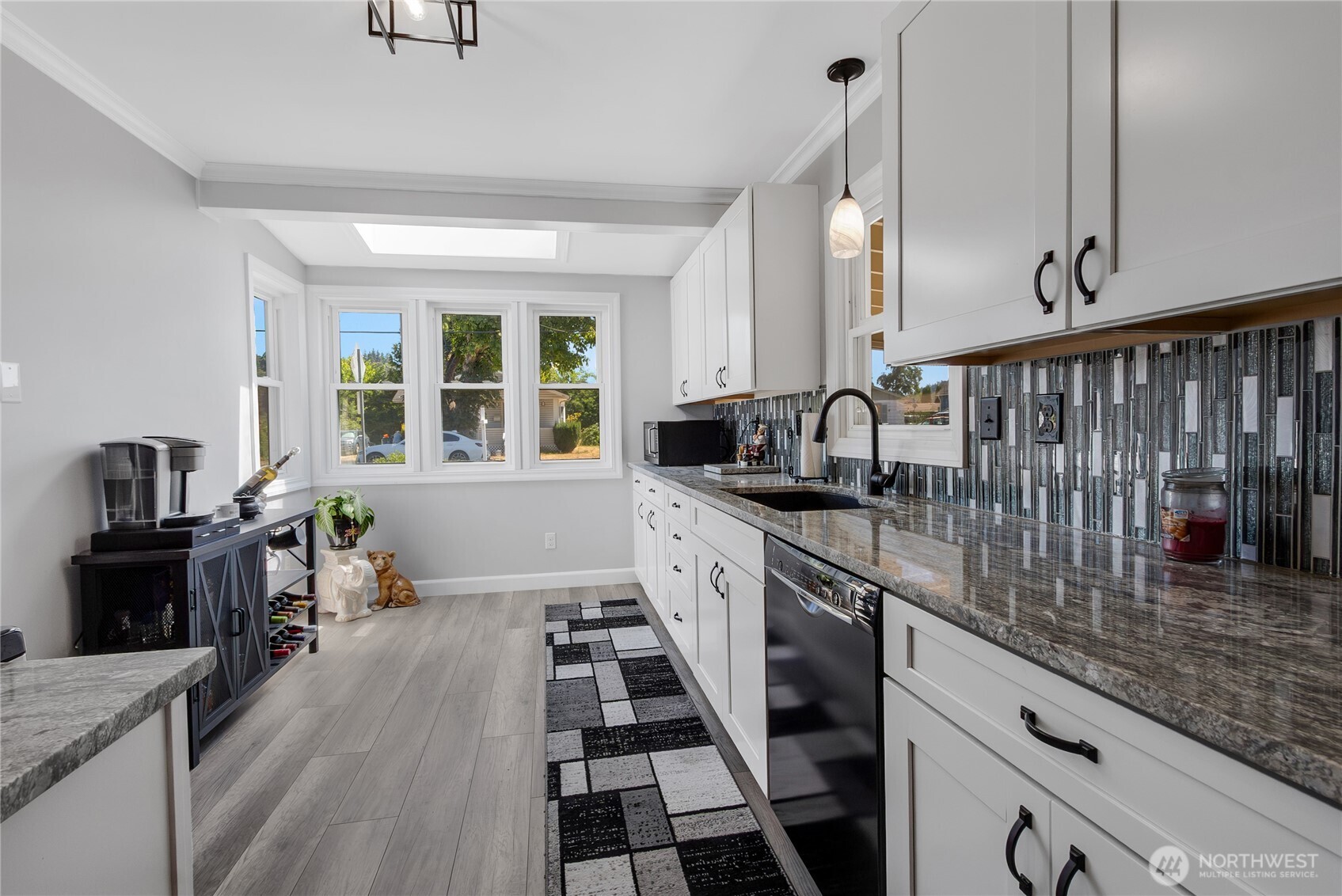 223 R Street Southeast Auburn, WA 98002 - Photo 8 of 23 a kitchen with granite countertop lots of counter top space and wooden floor