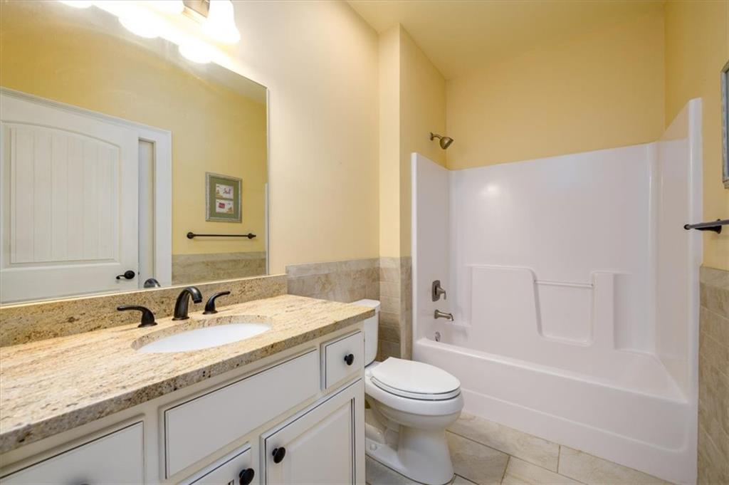725 County Farm Road Jefferson, GA 30549 - Photo 18 of 43 a bathroom with a granite countertop sink toilet and shower