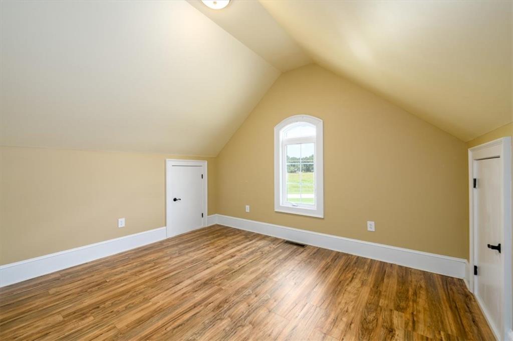 725 County Farm Road Jefferson, GA 30549 - Photo 27 of 43 an empty room with wooden floor and windows