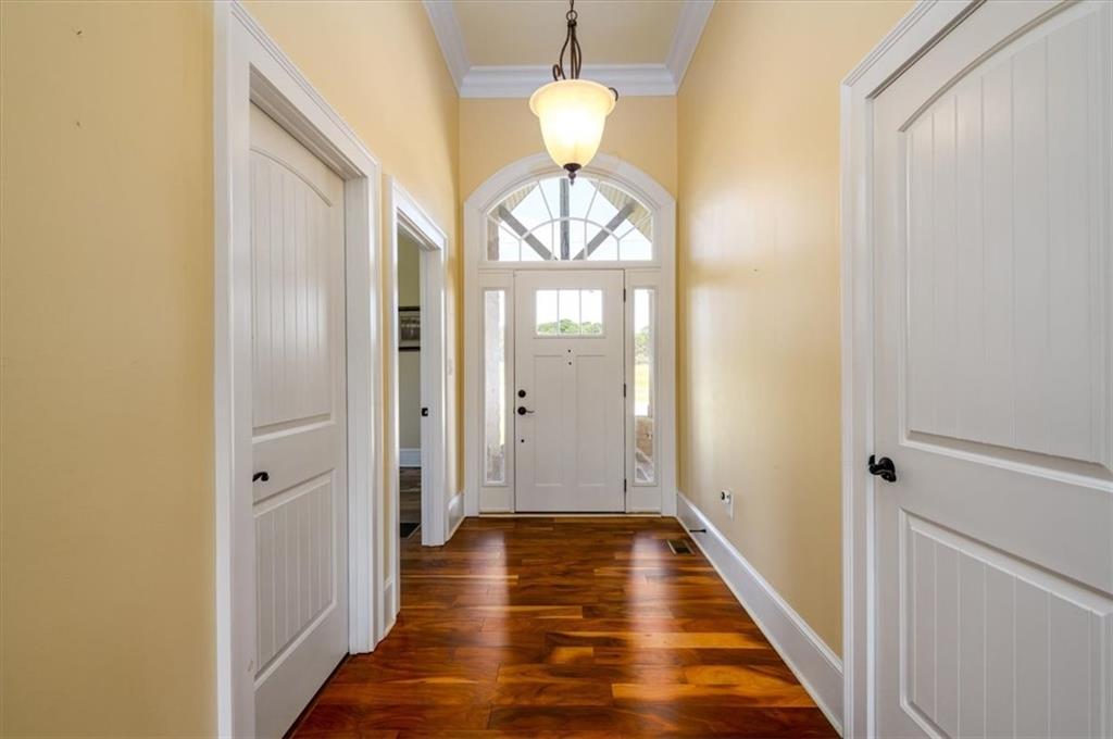 725 County Farm Road Jefferson, GA 30549 - Photo 5 of 43 a view of a hallway with wooden floor and a dining room