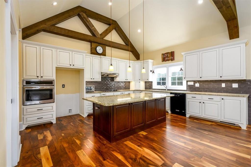 725 County Farm Road Jefferson, GA 30549 - Photo 8 of 43 a kitchen with stainless steel appliances kitchen island granite countertop a stove a sink and a refrigerator