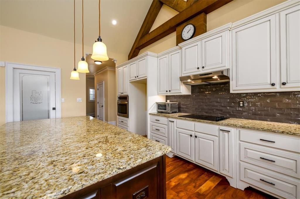 725 County Farm Road Jefferson, GA 30549 - Photo 10 of 43 a kitchen with kitchen island granite countertop wooden cabinets and a refrigerator