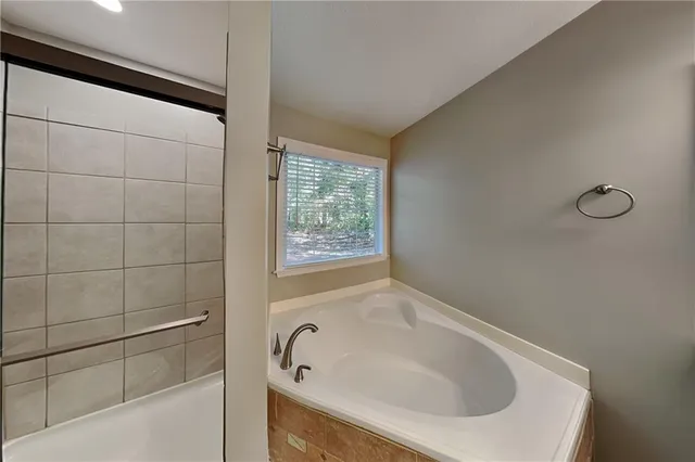 a bathroom with a tub and a shower