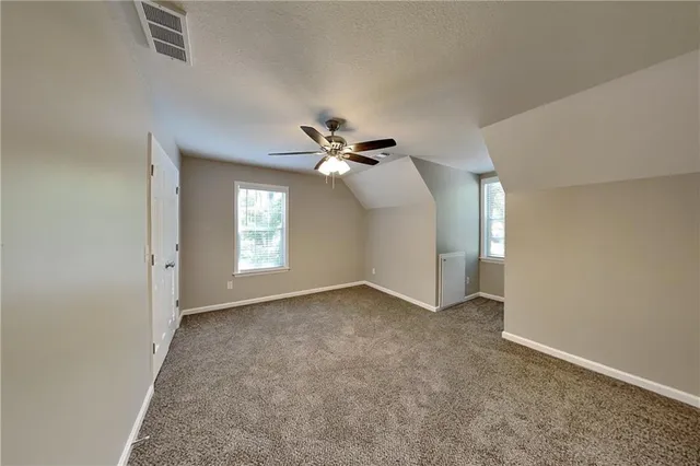 a view of empty room with ceiling fan