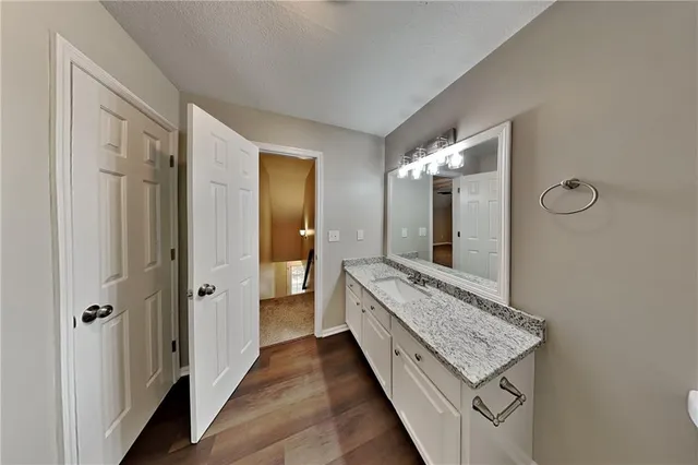 a bathroom with a double vanity sink and mirror with shower
