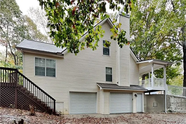 a view of house with a yard and sitting area