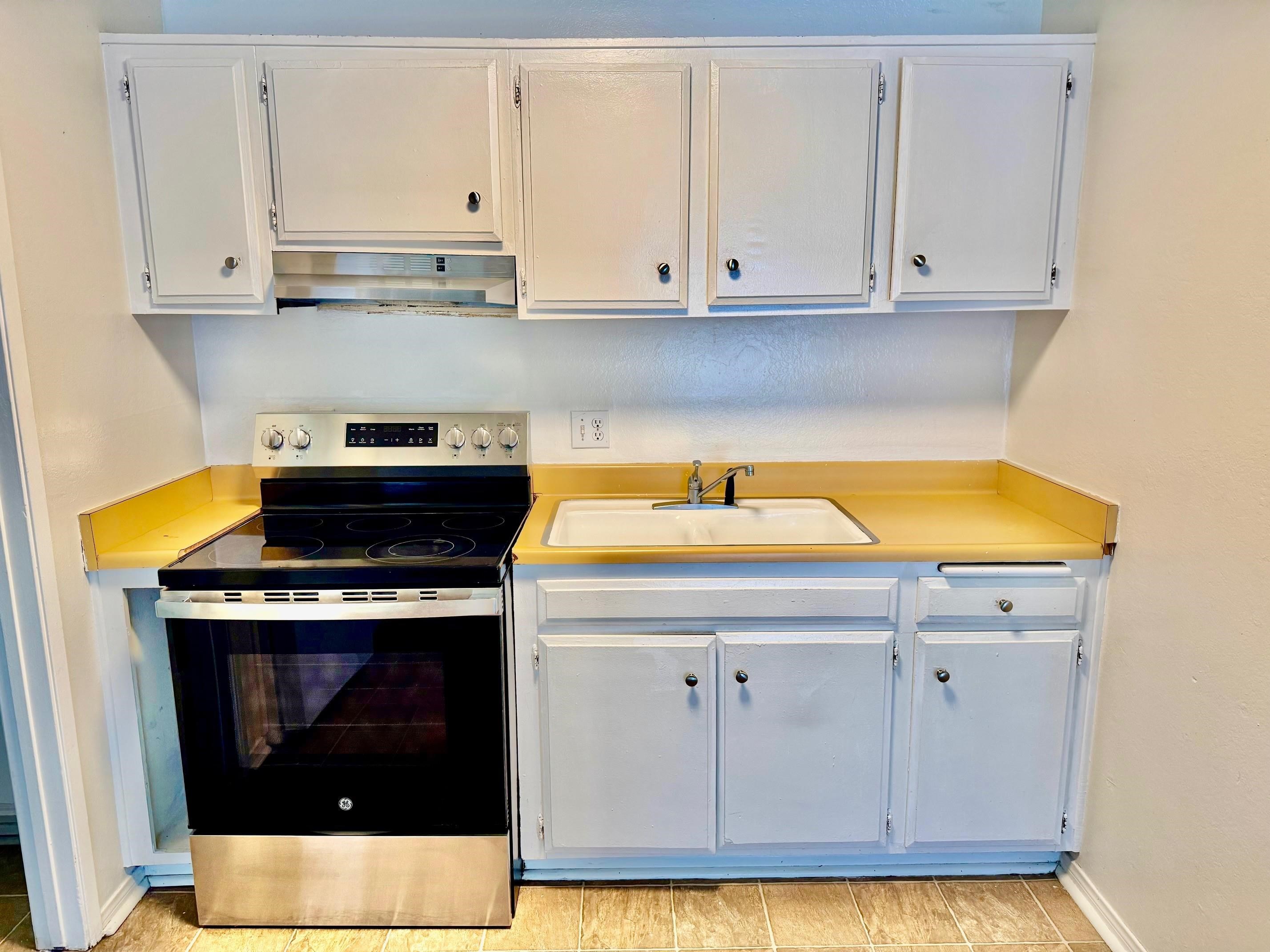 137 Laurel Mountain Road, Unit 302 Mammoth Lakes, CA 93546 - Photo 2 of 12 a kitchen with a sink a stove and cabinets