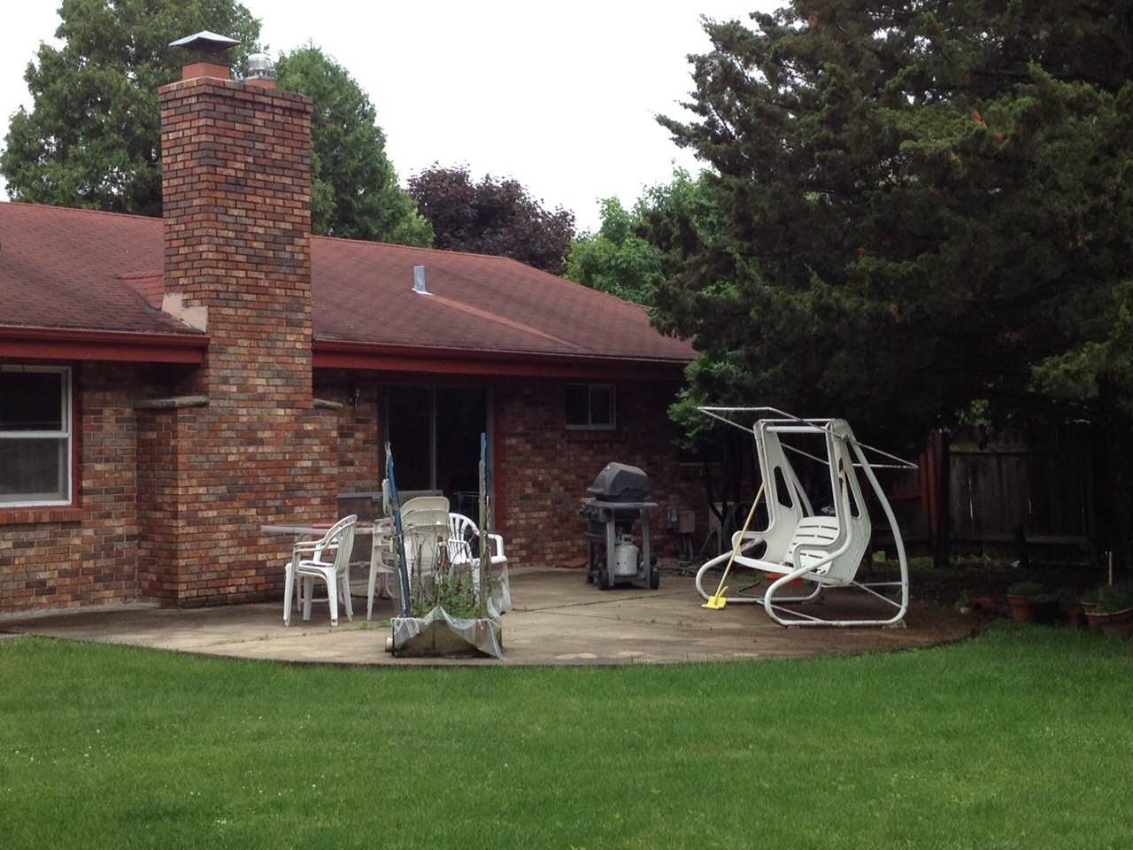 5206 Brookview Road Rockford, IL 61107 - Photo 17 of 23 a front view of a house with garden and trees