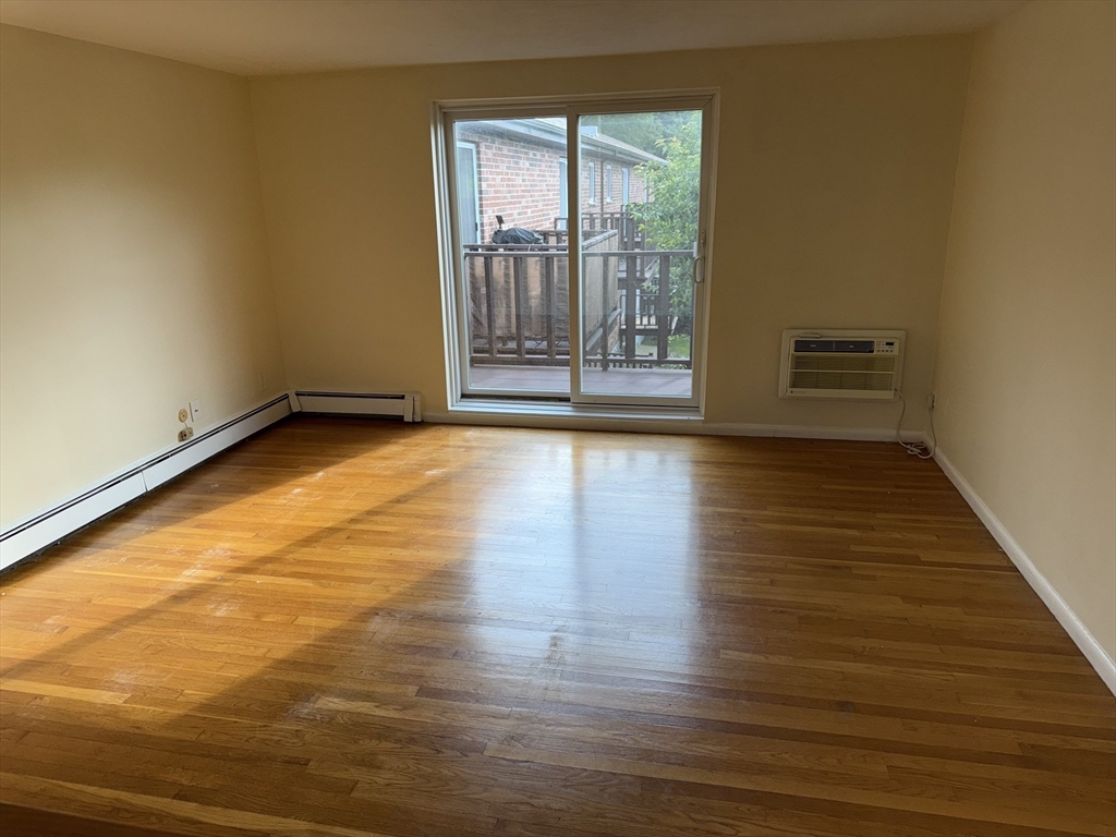 40 Westgate Road, Unit 5 Chestnut Hill, MA 02467 - Photo 14 of 33 a view of an empty room with wooden floor and a window