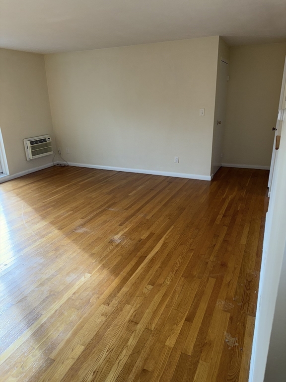 40 Westgate Road, Unit 5 Chestnut Hill, MA 02467 - Photo 16 of 33 a view of an empty room with wooden floor and a window