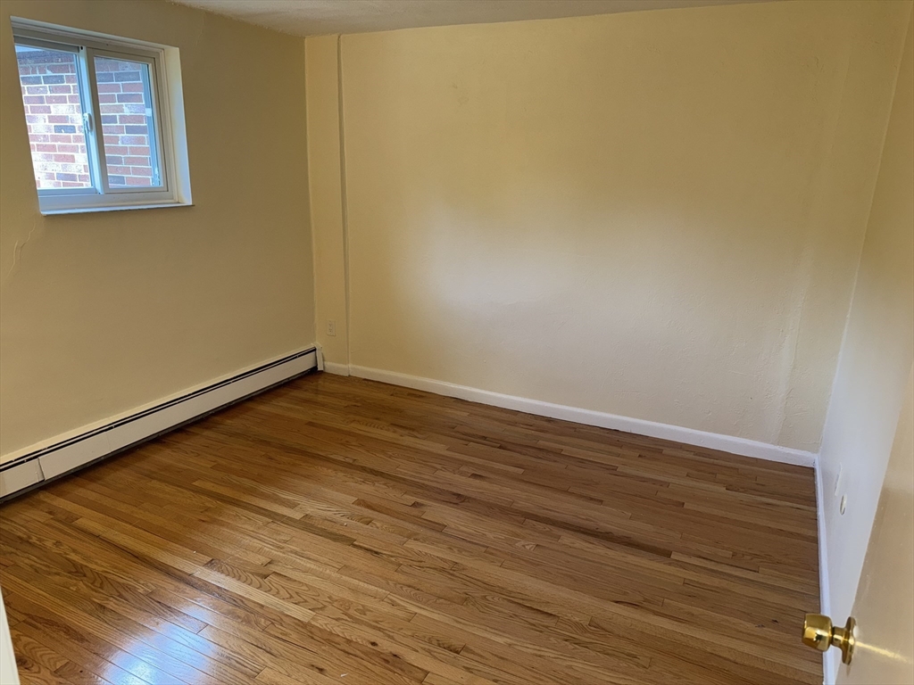 40 Westgate Road, Unit 5 Chestnut Hill, MA 02467 - Photo 17 of 33 a view of empty room with wooden floor