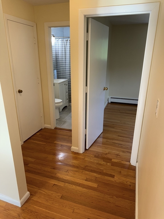 40 Westgate Road, Unit 5 Chestnut Hill, MA 02467 - Photo 19 of 33 a view of a hallway with wooden floor and a bathroom