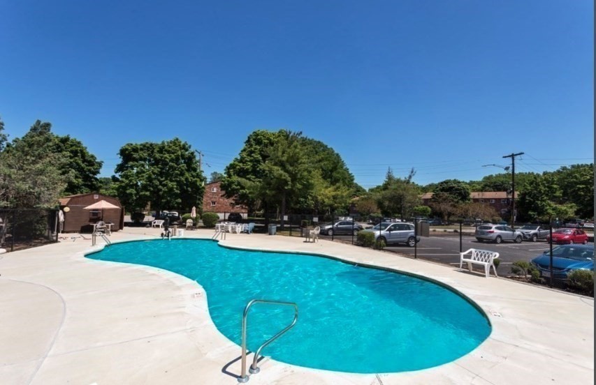 40 Westgate Road, Unit 5 Chestnut Hill, MA 02467 - Photo 32 of 33 a view of a swimming pool and lounge chairs
