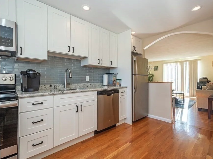 40 Westgate Road, Unit 5 Chestnut Hill, MA 02467 - Photo 5 of 33 a kitchen with granite countertop white cabinets and refrigerator