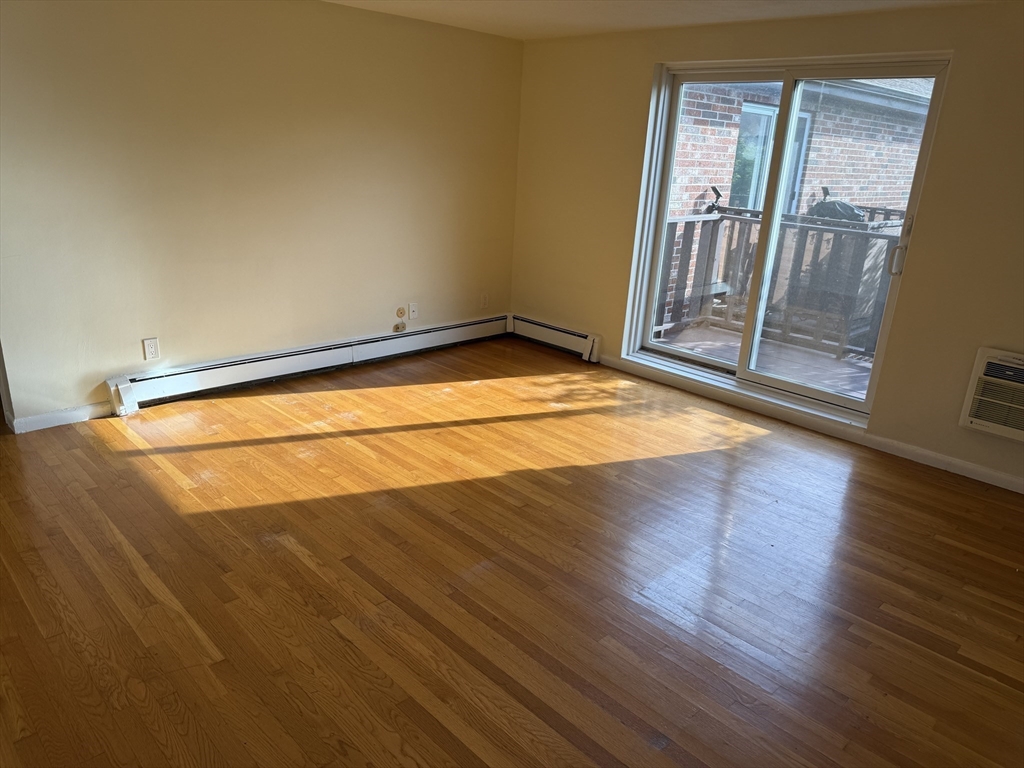 40 Westgate Road, Unit 5 Chestnut Hill, MA 02467 - Photo 8 of 33 an empty room with wooden floor and door