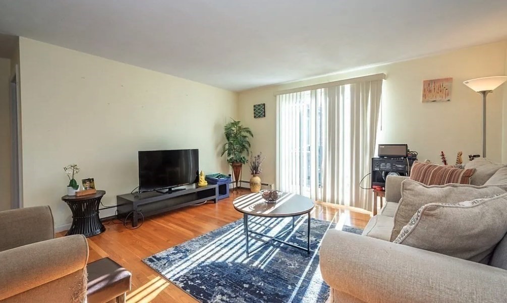 40 Westgate Road, Unit 5 Chestnut Hill, MA 02467 - Photo 9 of 33 a living room with furniture and a flat screen tv