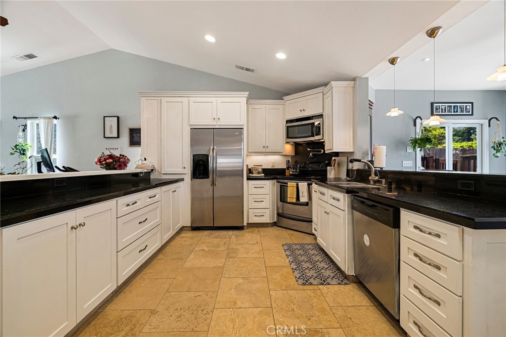 13 Avante Way Chico, CA 95973 - Photo 13 of 58 a kitchen with stainless steel appliances kitchen island granite countertop a sink and cabinets