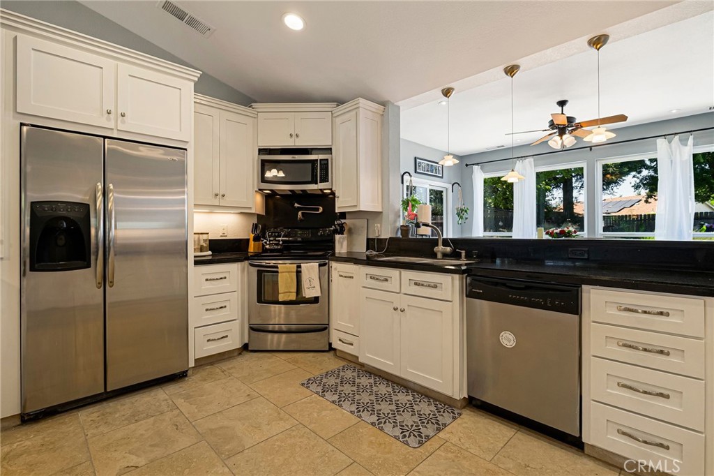 13 Avante Way Chico, CA 95973 - Photo 14 of 58 a kitchen with granite countertop a sink stainless steel appliances and counter space