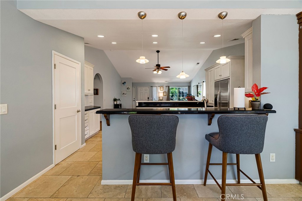 13 Avante Way Chico, CA 95973 - Photo 19 of 58 a dining room with stainless steel appliances kitchen island a table chairs and a refrigerator