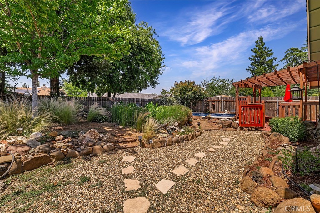13 Avante Way Chico, CA 95973 - Photo 43 of 58 a view of a backyard with plants and a lake view
