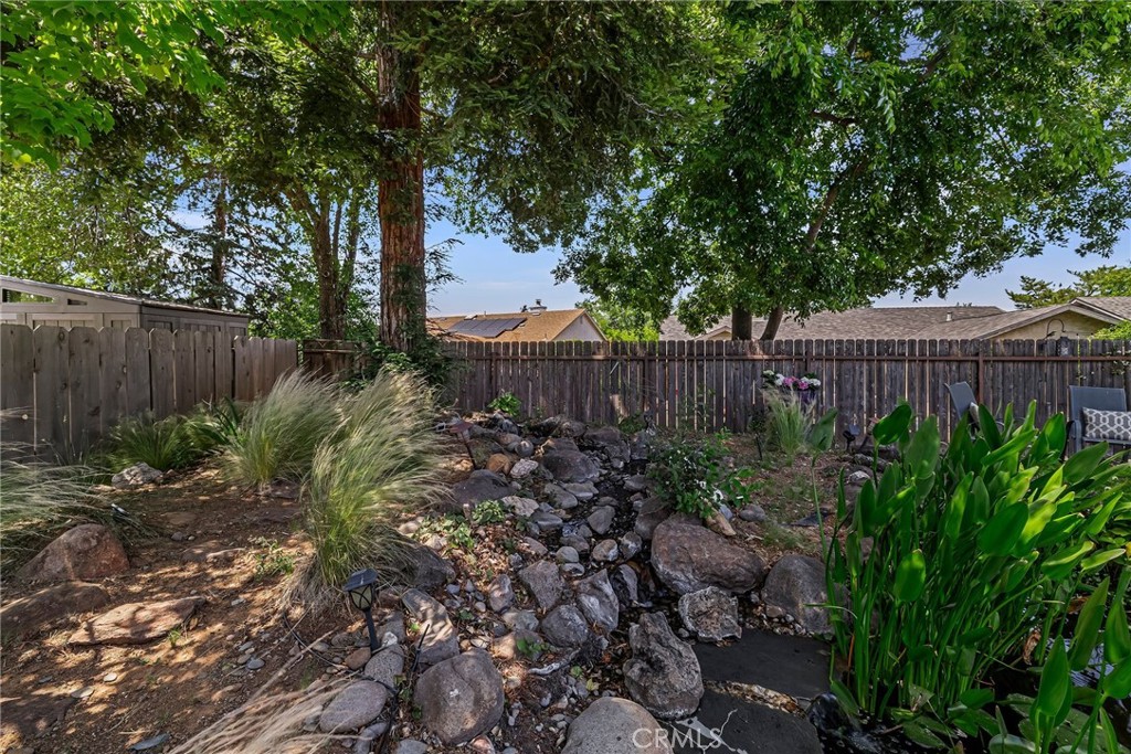 13 Avante Way Chico, CA 95973 - Photo 49 of 58 a view of a backyard with large trees and wooden fence