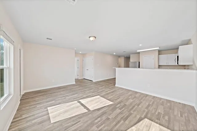 a view of a kitchen with wooden floor