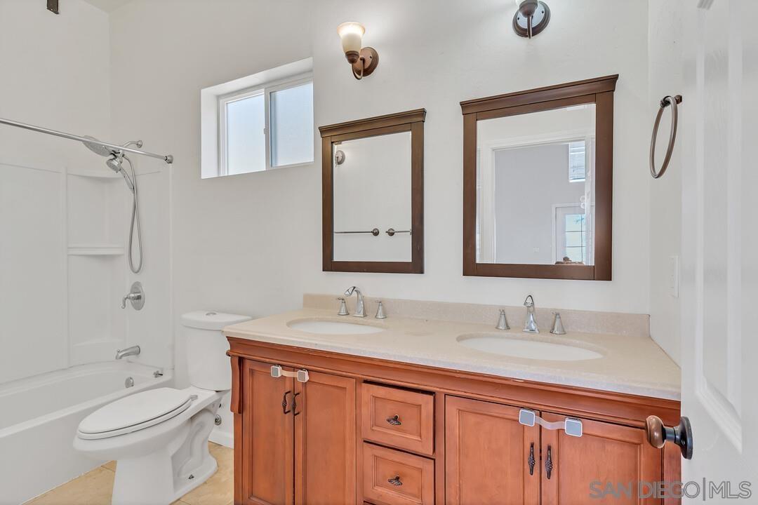 23611 Old Ranch Road Alpine, CA 91901 - Photo 13 of 25 a bathroom with a granite countertop sink a toilet and a mirror