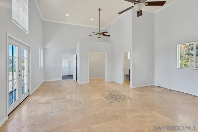 a kitchen with stainless steel appliances granite countertop a refrigerator a sink dishwasher a stove and white countertops with wooden floor