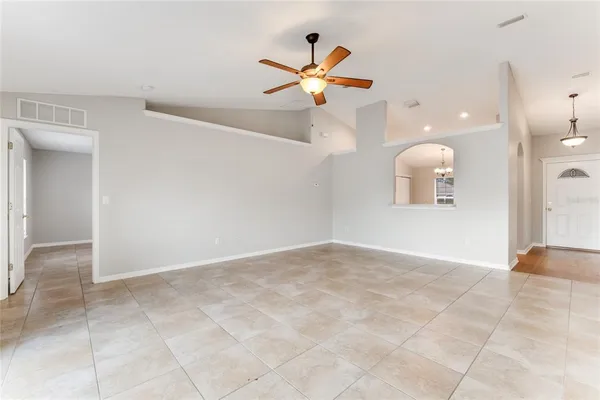 a view of a livingroom with a ceiling fan and window