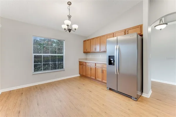a kitchen with stainless steel appliances a refrigerator sink and wooden floor