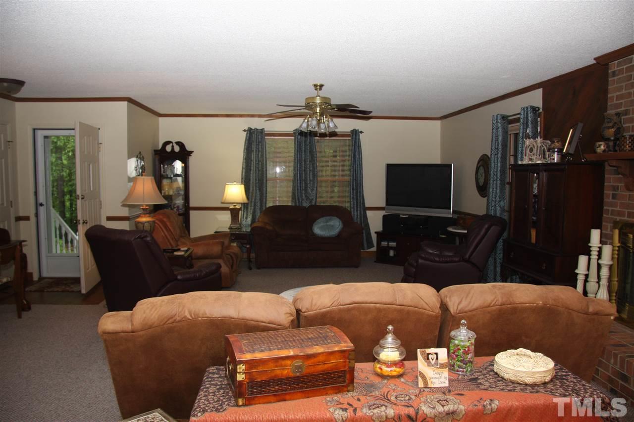 1825 Rc Watson Road Wendell, NC 27591 - Photo 2 of 18 a living room with furniture a flat screen tv and kitchen view