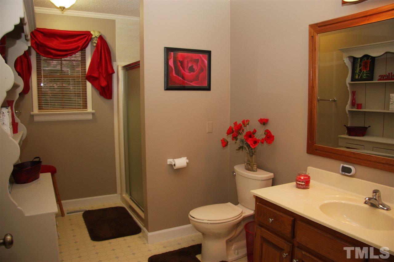 1825 Rc Watson Road Wendell, NC 27591 - Photo 12 of 18 a bathroom with a sink mirror vanity and toilet