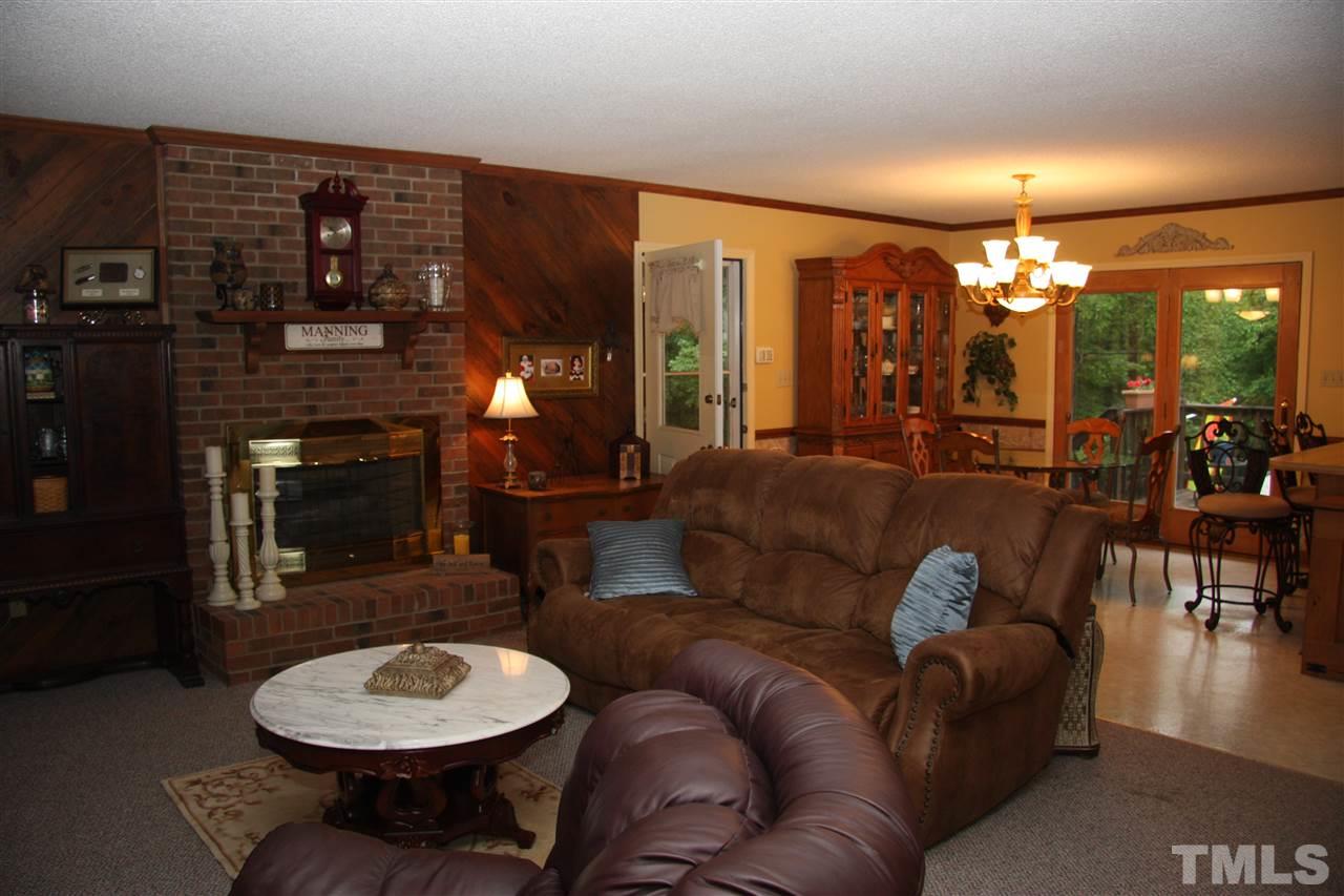 1825 Rc Watson Road Wendell, NC 27591 - Photo 3 of 18 a living room with furniture a lamp and a fireplace