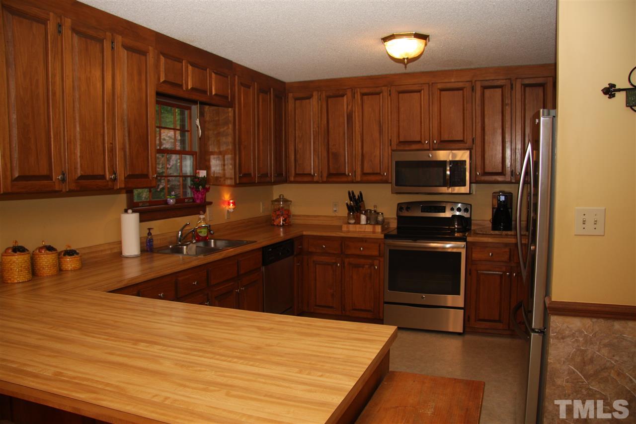 1825 Rc Watson Road Wendell, NC 27591 - Photo 5 of 18 a kitchen with a refrigerator stove and sink