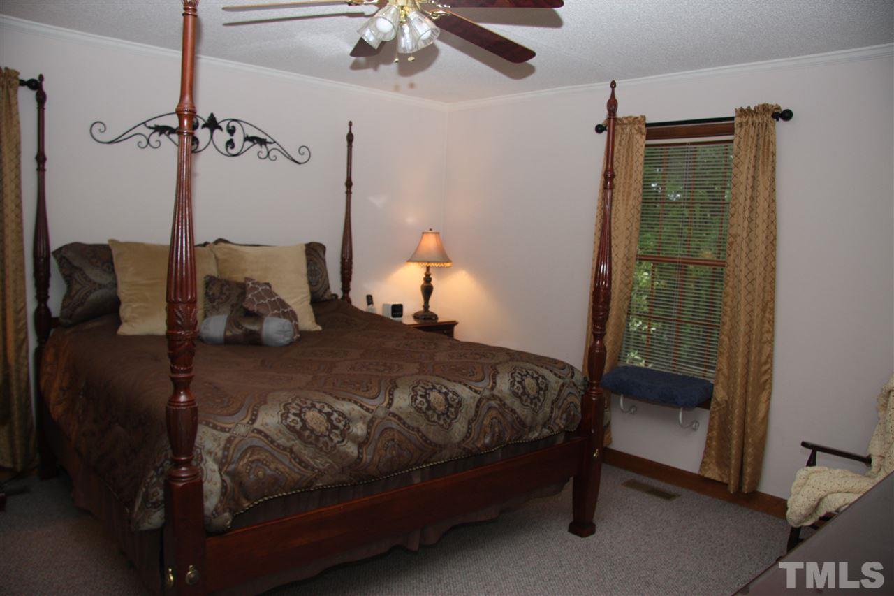1825 Rc Watson Road Wendell, NC 27591 - Photo 9 of 18 a bedroom with a bed and a mirror